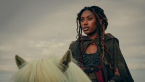 Sophia Brown as Eile in The Witcher: Blood Origin, riding a white horse