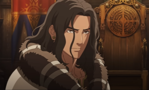 The animated character of Wulf in War Of The Rohirrim, in close-up. He has long dark brown hair, and wears a light brown cloak with a dark brown fur-lined collar.