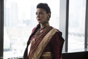 Shohreh Aghdashloo as Chrisjen Avasarala in The Expanse. She has long dark hair in a braid. She is wearing a red-and-gold sari.